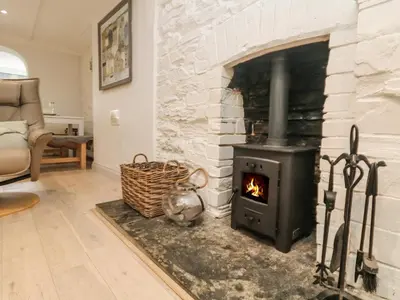a fireplace in a living room with a stove at Riversdale Cottage in Wadebridge