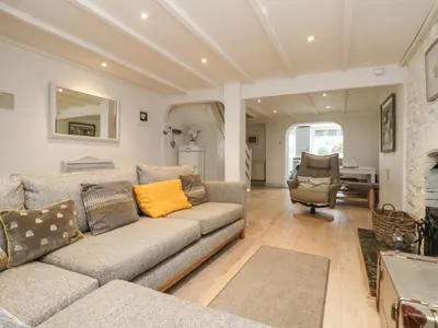 a living room with a couch and a chair at Riversdale Cottage in Wadebridge