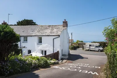 a white house with a sign that says we are almost allown at Karrek in Tintagel