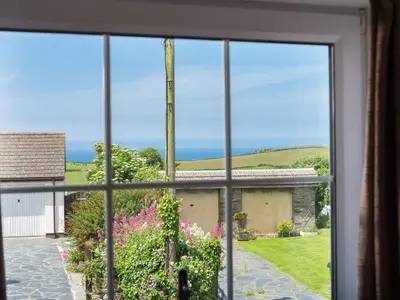an open window with a view of the ocean from a house at Karrek in Tintagel
