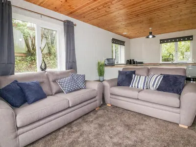 two couches in a living room with blue pillows at Lodge One in Truro