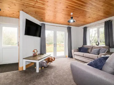 a living room with a couch and a table at Lodge One in Truro