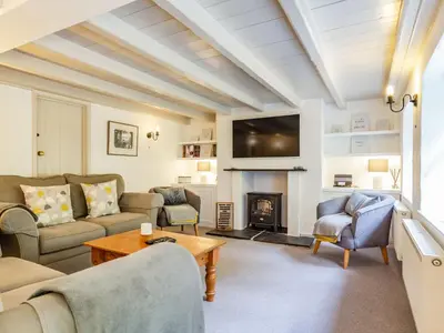a living room with a couch and a fireplace at 3 Rose Cottages in St. Agnes