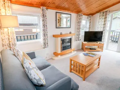 a living room with a couch and a tv at Smugglers Shack in Polperro
