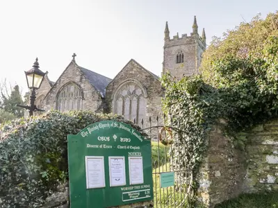 a sign in front of a church with a gate at 1 Rose Cottages in Looe