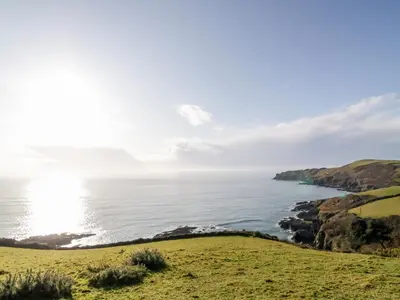 a view of the ocean from a hill at 1 Rose Cottages in Looe