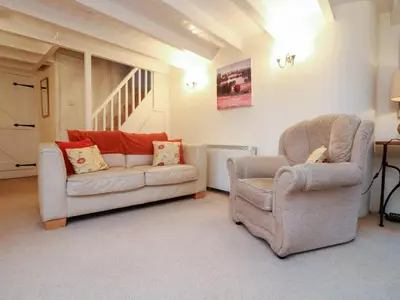 a living room with two chairs and a couch at 1 Rose Cottages in Looe