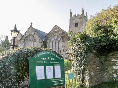 a church with a sign in front of a fence at 3 Rose Cottages in Looe
