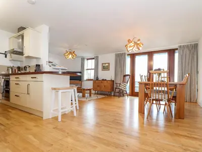 a kitchen and dining room with a table and chairs at Ocean Blue in Penzance