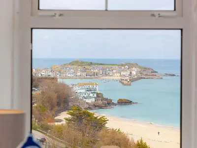 a view of a beach from a window at Trevose in St Ives