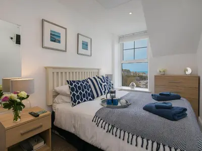 a bedroom with a bed with a tray on it at Trevose in St Ives