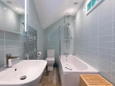 a bathroom with a tub and a toilet and a sink at Trevose in St Ives