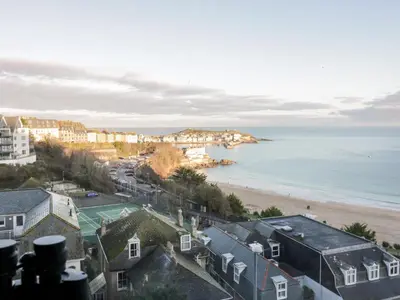 a view of a beach with houses and the ocean at Trevose in St Ives