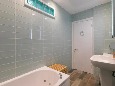 a bathroom with a tub and a sink at Trevose in St Ives