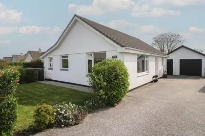 a white house with a driveway at Tremar in St Ives