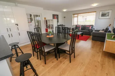 a kitchen and living room with a table and chairs at Tremar in St Ives