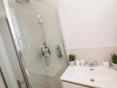 a bathroom with a shower and a sink at Driftwood Haven in St Ives
