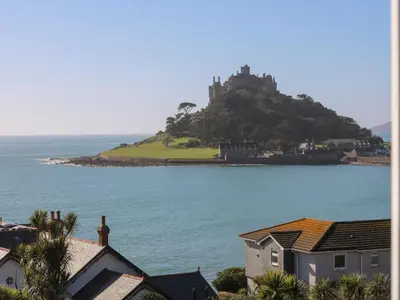 a castle on an island in a body of water at Ocean View in Marazion