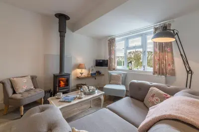 a living room with a couch and a fireplace at Miss Fishers in Port Isaac