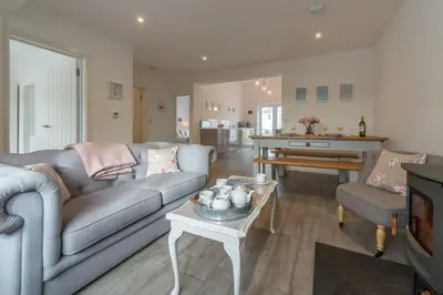 a living room with a couch and a table at Miss Fishers in Port Isaac