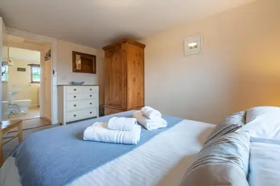a bedroom with two towels on a bed at Spring Barn in Polzeath
