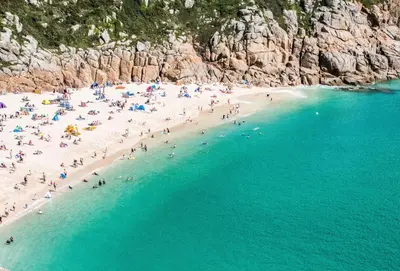 a group of people on a beach near the water at 9 Fernhill Penthouse in Carbis Bay