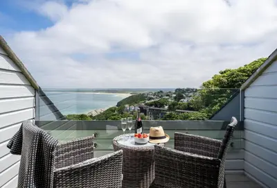 a balcony with a table and chairs with a view at 9 Fernhill Penthouse in Carbis Bay