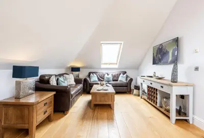 a living room with a couch and a table at 9 Fernhill Penthouse in Carbis Bay