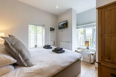 a bedroom with a bed with two pillows on it at 5 Fernhill in Carbis Bay