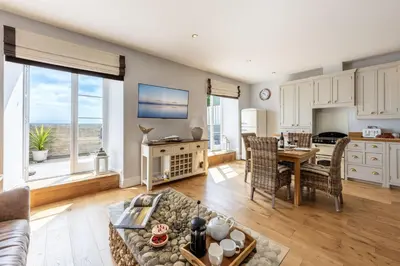 a living room with a couch and a table at 5 Fernhill in Carbis Bay