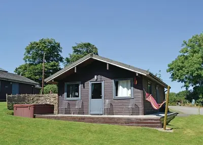 a small house with a flag in front of it at Avallon Lodges in Launceston