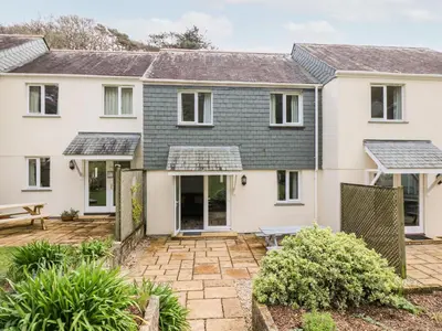 a house with a courtyard in front of it at Compass Point in Falmouth
