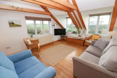 a living room with two couches and a tv at Kernyk in Helston