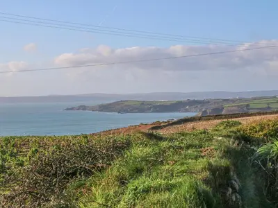 a view of the ocean from a grassy hill at Kernyk in Helston