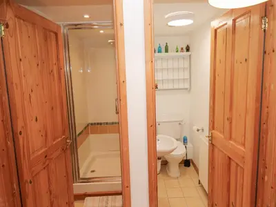 a bathroom with a toilet and a shower and a sink at Kernyk in Helston