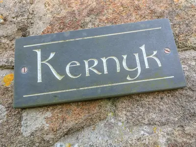 a sign on the side of a rock at Kernyk in Helston