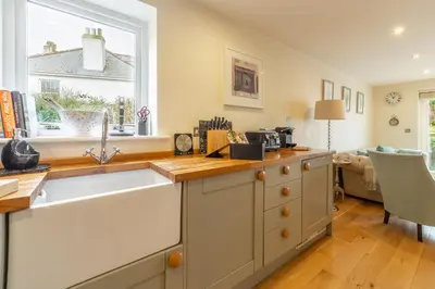 a kitchen with a sink and a window at 6 Sandy Lane in Carbis Bay