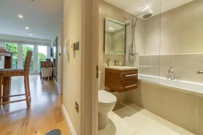 a bathroom with a toilet and a sink and a tub at 6 Sandy Lane in Carbis Bay