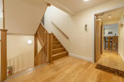 a staircase in a home with wooden floors at 6 Sandy Lane in Carbis Bay