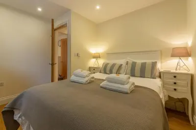 a bedroom with a bed with towels on it at 6 Sandy Lane in Carbis Bay