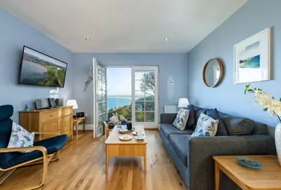 a living room with a couch and a table at The View in Carbis Bay