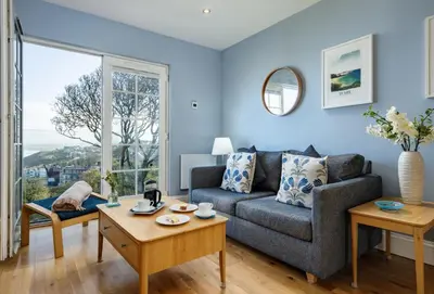 a living room with a couch and a table at The View in Carbis Bay