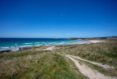 a dirt road leading to a beach with the ocean at The View in Carbis Bay