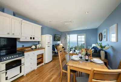 a kitchen and dining room with a table and chairs at The View in Carbis Bay