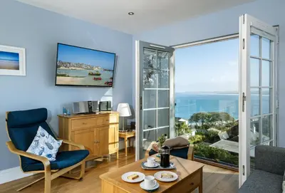 a living room with a view of the ocean at The View in Carbis Bay