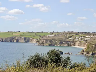 a view of a body of water with a beach at Millys Nook in St Austell