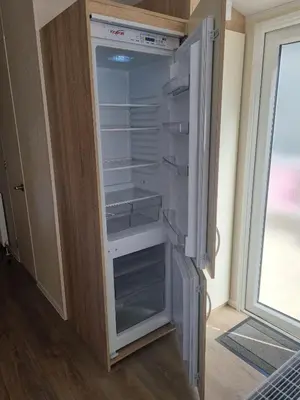 a refrigerator with its door open in a room at Cozy 3 bedroom Caravan, Sleeps 8, at Parkdean Newquay Holiday Park in Newquay
