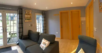 a living room with a couch and two chairs at 41 Tudor Court in Hayle