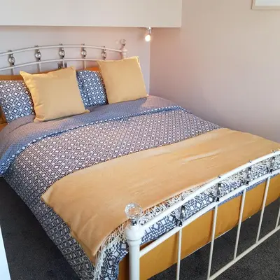 a bedroom with a bed with a metal frame at Chynoweth Court in Newquay