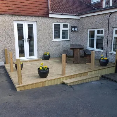 a wooden deck in front of a house at Chynoweth Court in Newquay